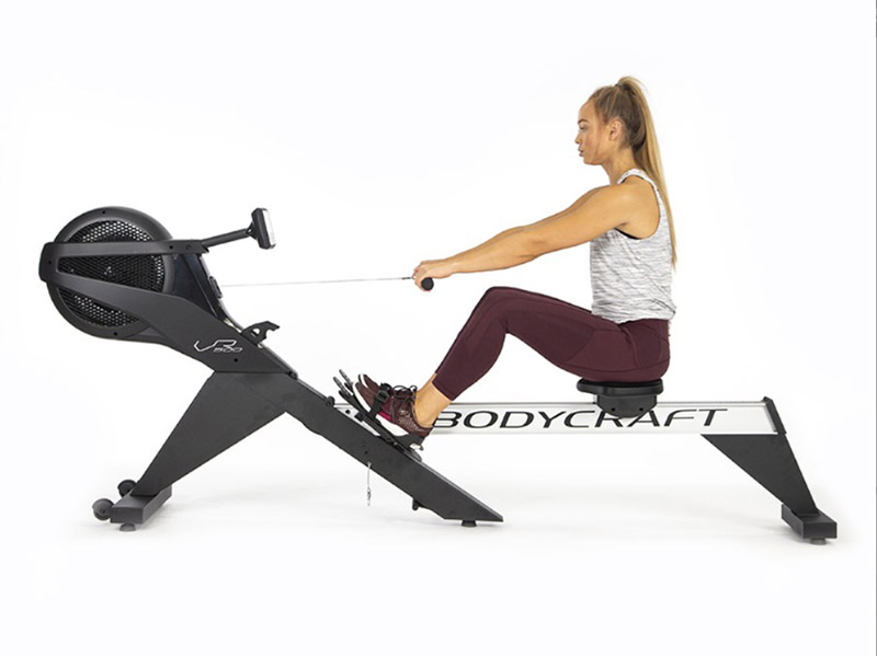 woman on a Bodycraft Pro Air Rowing Machine