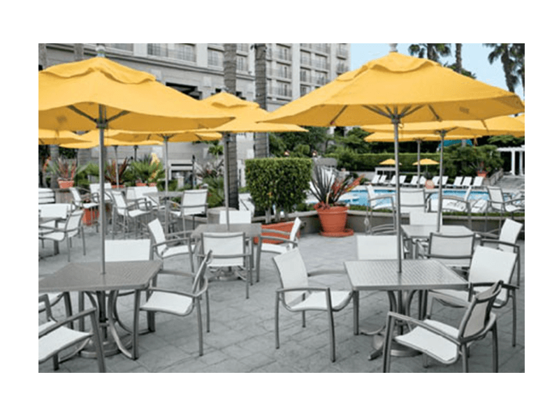 Tropitone Tables and Chairs with Yellow Umbrellas