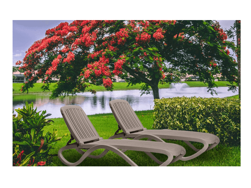 two Nardi chaise lounges on grass