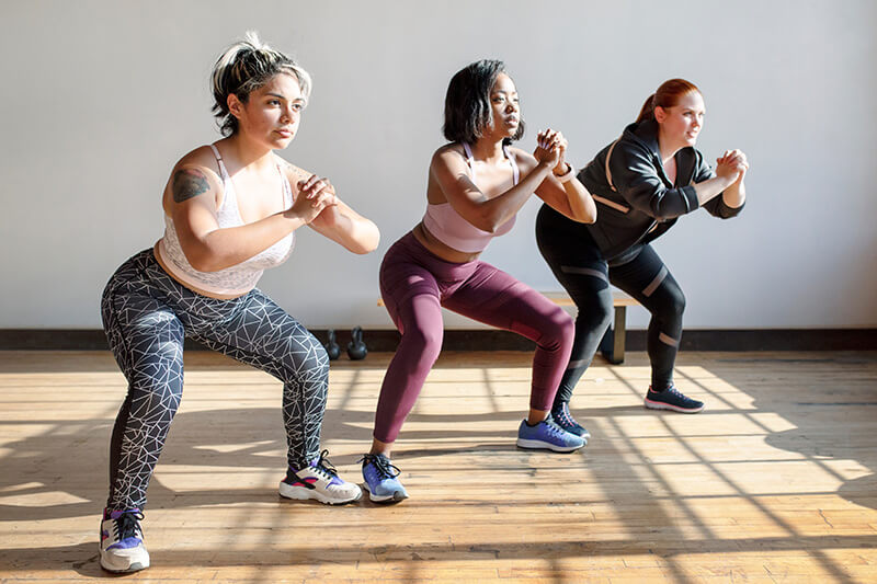 3 women doing squats