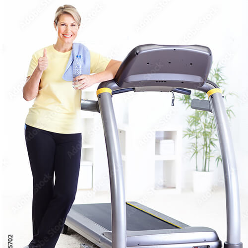 Image of senior woman next to a treadmill