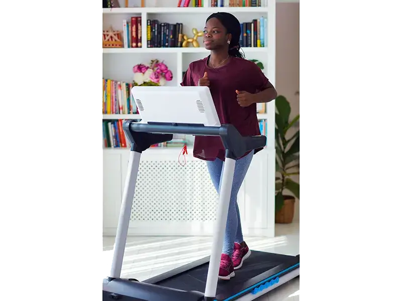 woman walking on treadmill at home