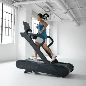 Man Running On A True Fitness Vapor Stryker Treadmill